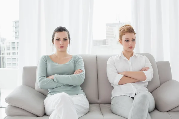 Unhappy friends not talking after argument on the couch — Stock Photo, Image