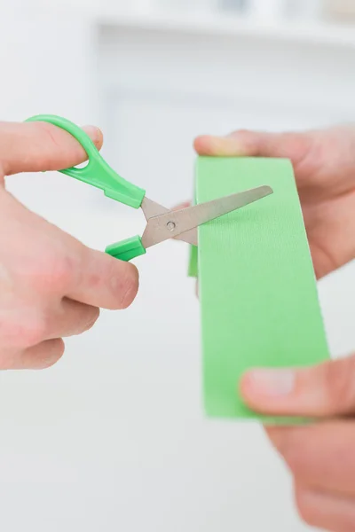 Hands holding kinesio tape and scissors — Stock Photo, Image