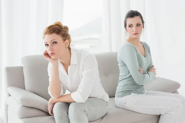 Unhappy friends not talking after argument on the couch — Stock Photo, Image