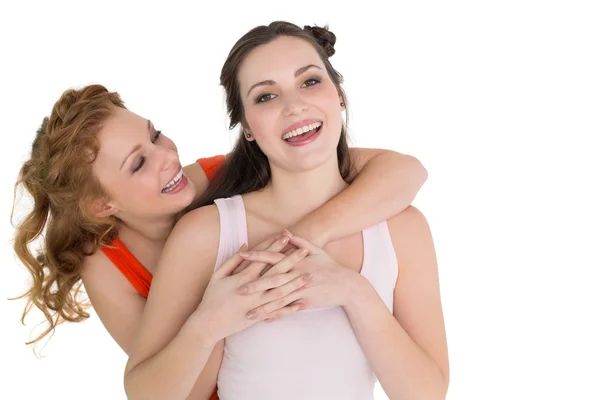 Young female embracing her cheerful friend — Stock Photo, Image
