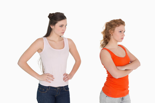 Unhappy young female friends not talking after argument