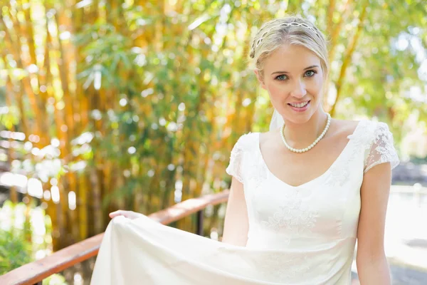 Lächelnde blonde Braut in Perlenkette blickt in die Kamera — Stockfoto