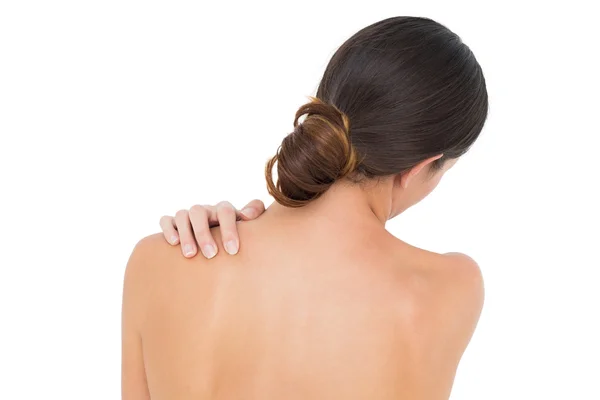 Close-up of a topless woman with shoulder pain — Stock Photo, Image