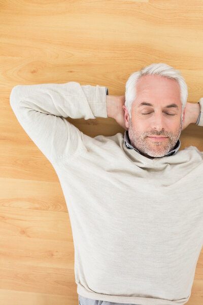 Overhead view of a man sleeping on parquet floor