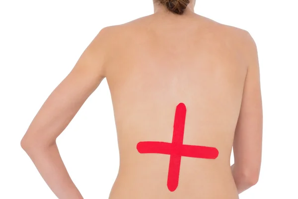 与红十字标志在背上的裸照合适的女人 — 图库照片