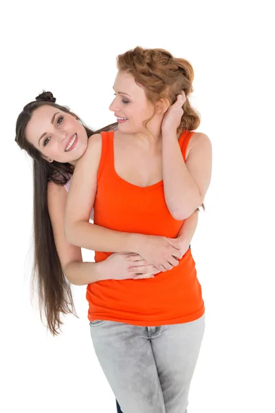 Cheerful young female embracing her friend — Stock Photo, Image