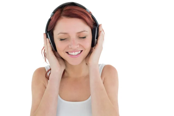 Beautiful woman enjoying music through headphones — Stock Photo, Image