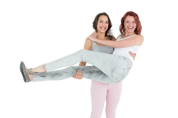 Portrait of a young female carrying her cheerful friend — Stock Photo, Image