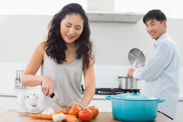 Pareja joven preparando comida juntos en la cocina — Foto de Stock