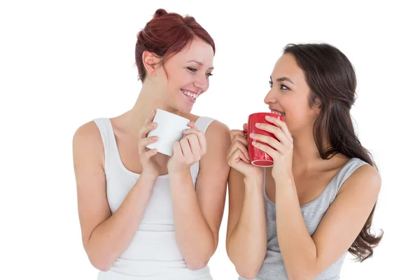Two smiling young female friends drinking coffee — Stock Photo, Image
