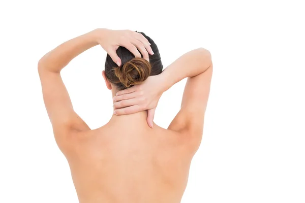 Rear view of a topless woman suffering from neck ache — Stock Photo, Image