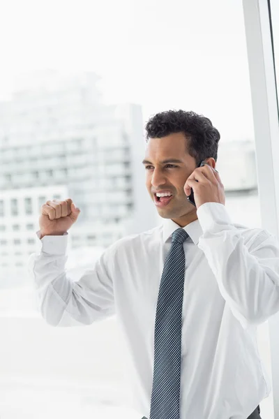 Cheerful businessman using cellphone in office — Stock Photo, Image