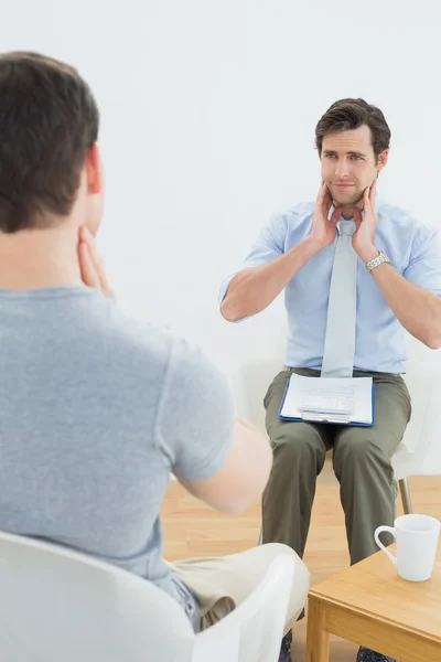 Well dressed male doctor in conversation with patient — Stock Photo, Image