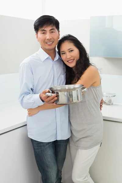 Young woman embracing man in kitchen — Stock Photo, Image