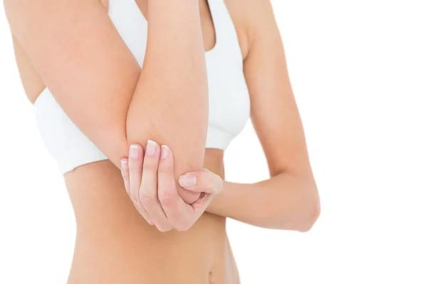 Close-up mid section of a fit woman with elbow pain — Stock Photo, Image