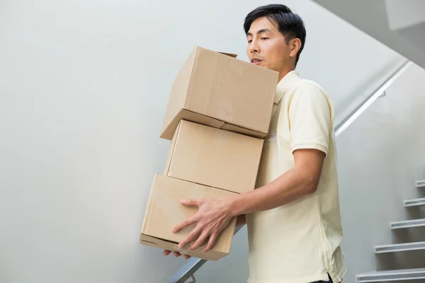 Young man carrying boxes — Stock Photo, Image