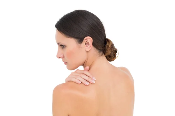 Close-up of a topless woman with shoulder pain — Stock Photo, Image