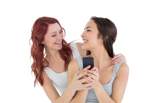 Two cheerful female friends with mobile phone — Stock Photo, Image