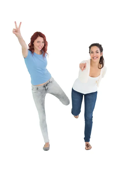 Two cheerful young female friends with hand gestures — Stock Photo, Image