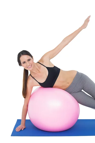 Portrait of a fit woman stretching on fitness ball — Stock Photo, Image