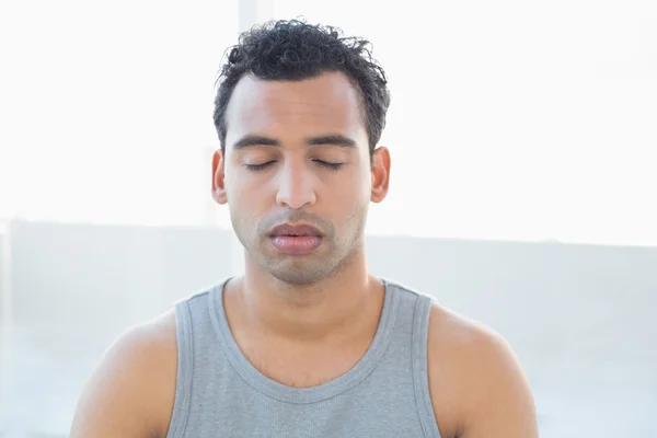 Närbild av en ung man mediterar med slutna ögon — Stockfoto