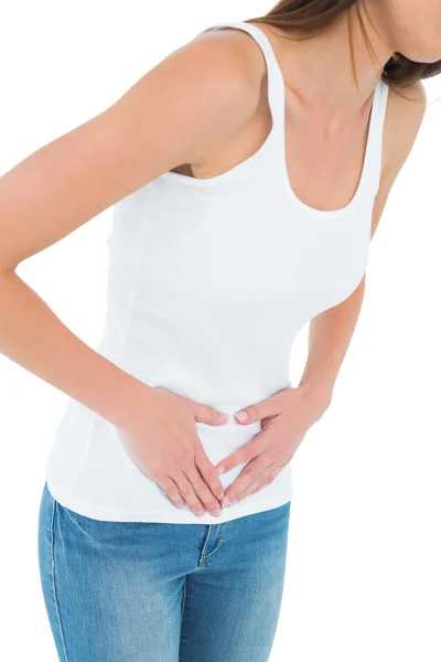 Close-up mid section of a casual woman with stomach pain — Stock Photo, Image