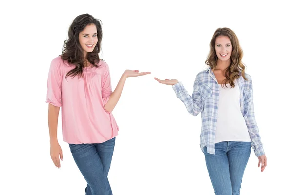 Female friends holding out their hands — Stock Photo, Image