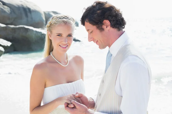 Pretty bride smiling at camera with husband — Stock Photo, Image