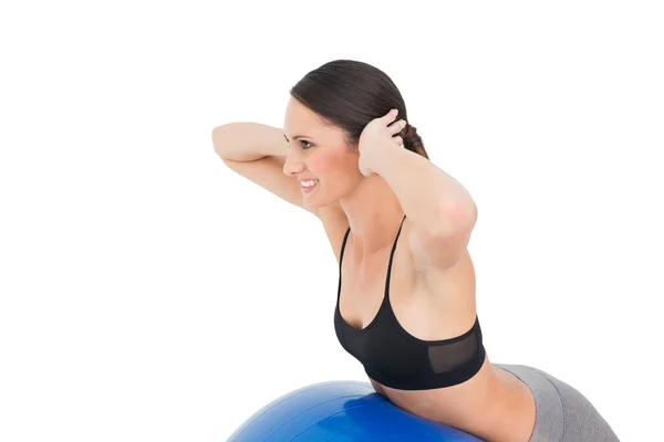 Side view of a fit woman stretching on fitness ball — Stock Photo, Image