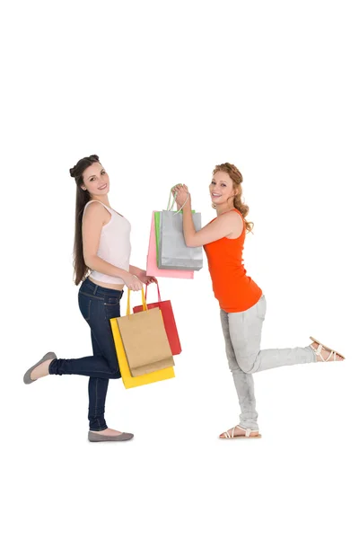 Feliz joven amigas con bolsas de compras —  Fotos de Stock