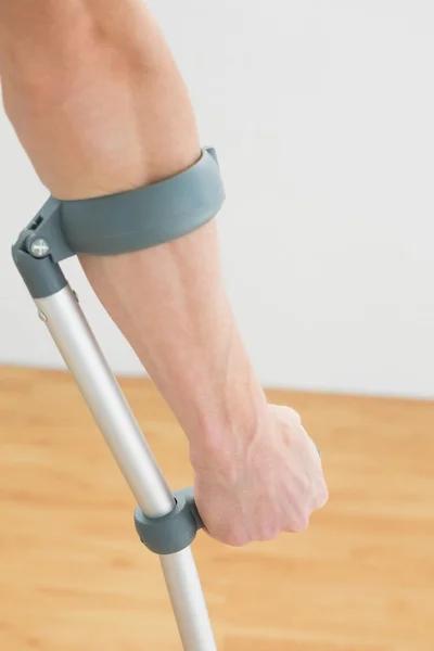 Close-up of a mans hand with crutch — Stock Photo, Image