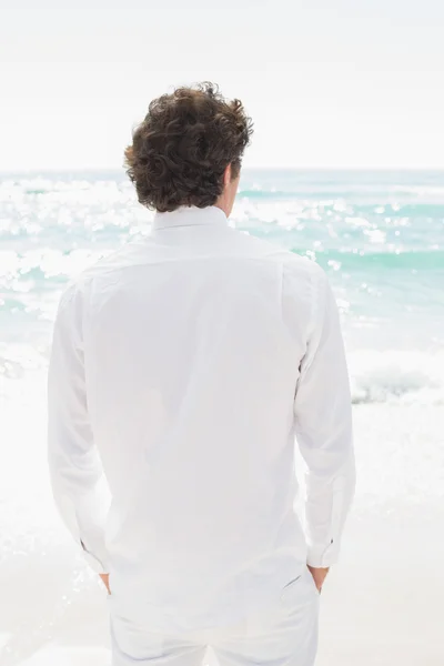 Handsome groom looking out to sea — Stock Photo, Image