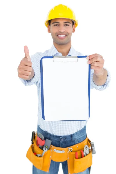 Handyman in yellow hard hat with clipboard gesturing thumbs up — Stock Photo, Image