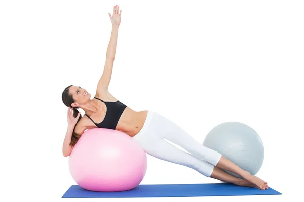 Full length of a fit woman stretching on fitness ball — Stock Photo, Image