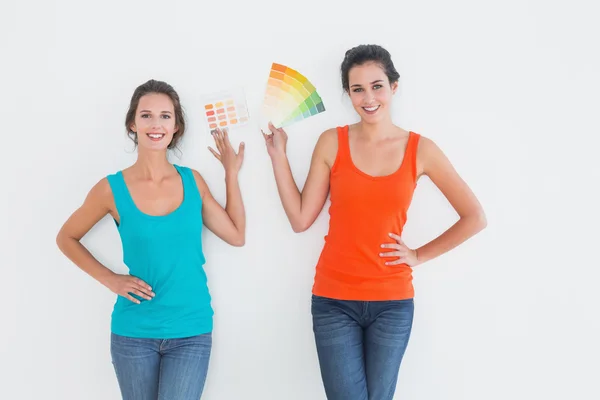 Vrouwelijke vrienden kiezen van de kleur voor het schilderen van een kamer — Stockfoto