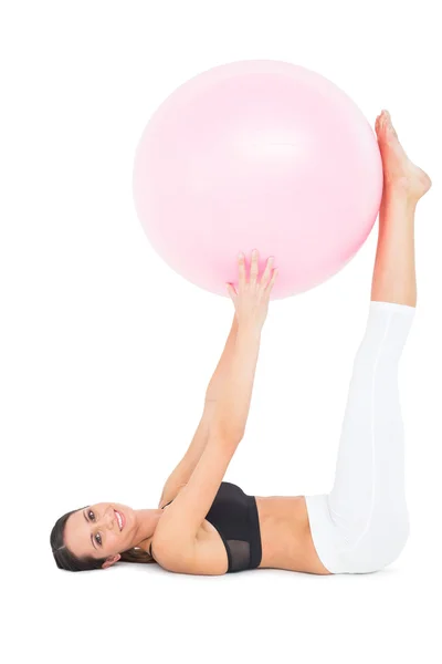 Side view of a fit woman exercising with fitness ball — Stock Photo, Image