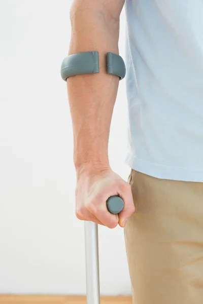 Close-up of a mans hand with crutch — Stock Photo, Image