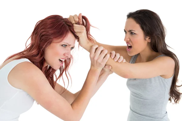 Mujer joven enojada tirando del pelo de la hembra en una pelea —  Fotos de Stock