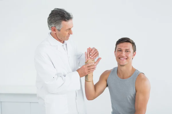 Врач осматривает руку пациента — стоковое фото