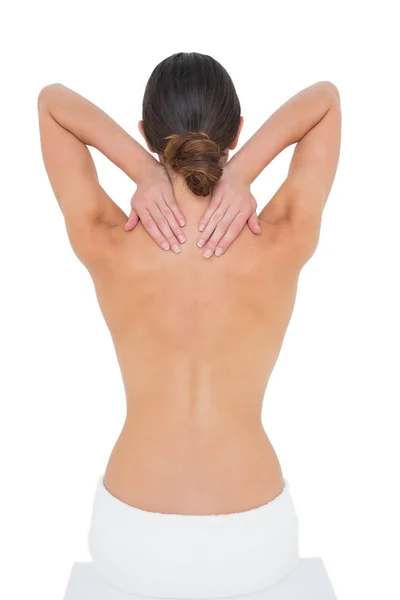 Rear view of a topless woman suffering from neck ache — Stock Photo, Image