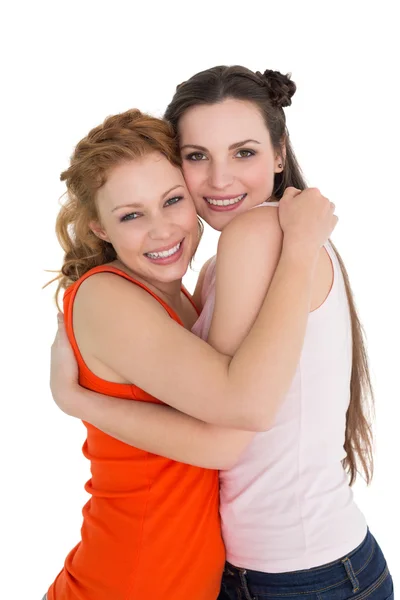 Side view portrait of a female embracing her friend Stock Photo