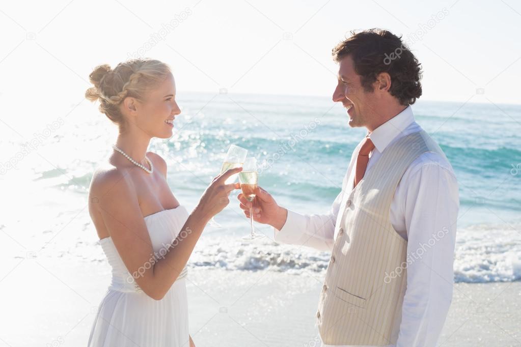 Newlyweds toasting with champagne smiling at camera