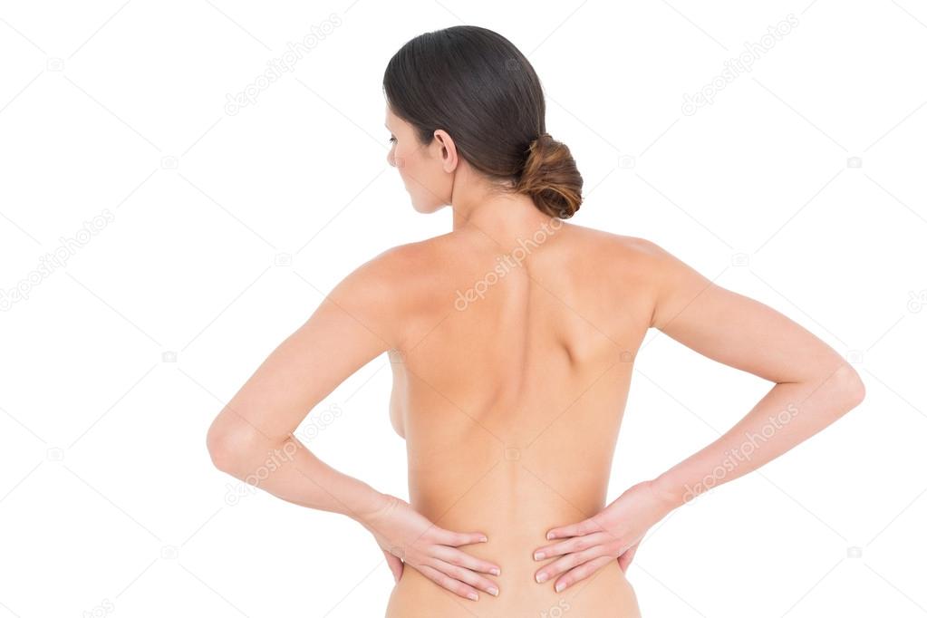 Rear view of a fit topless young woman with back pain Stock Photo by  ©lightwavemedia 37833931