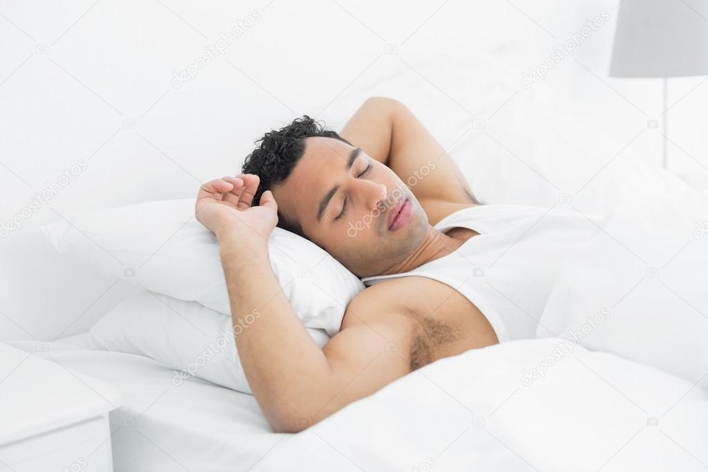 Young man sleeping in bed