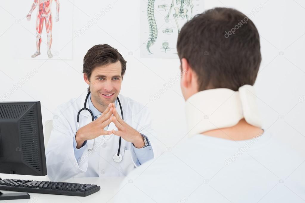 Doctor in conversation with patient at office