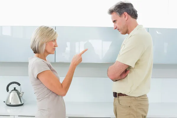 Angry couple arguing in kitchen — Stock Photo, Image