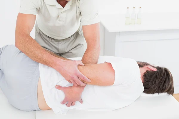 Male physiotherapist examining man's back — Stock Photo, Image