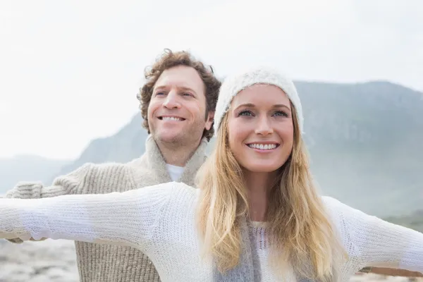 Casual young couple stretching hands out outdoors — Stock Photo, Image