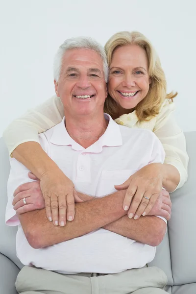 Happy senior woman embracing man from behind — Stock Photo, Image