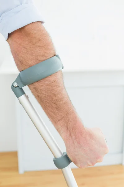 Close-up of a young man with crutch — Stock Photo, Image